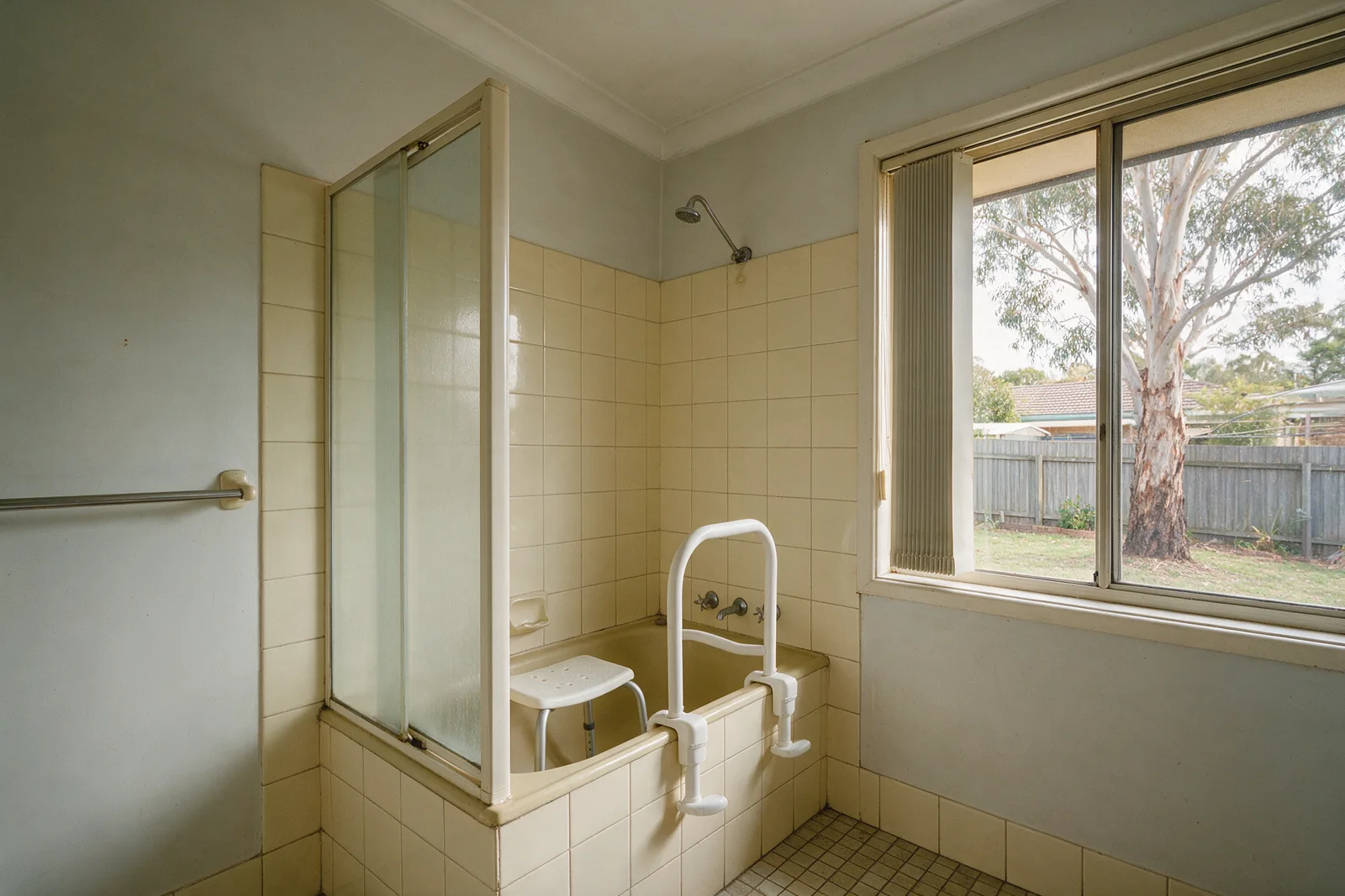 1970s Kambah bathroom with a clamp-on bath rail and shower stool in the bath
